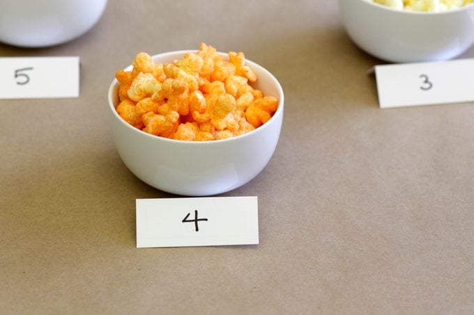Bowl with the number 4 filled with cheese puffs