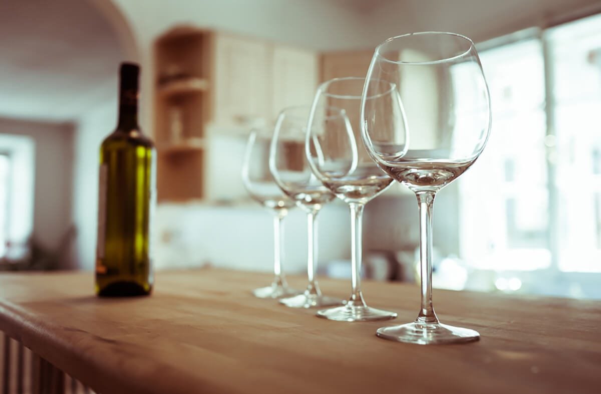 Wine glasses on a bar.