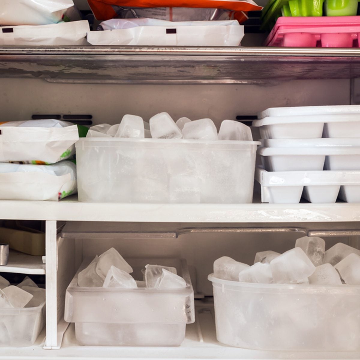 Freezer full of ice cubes and frozen food
