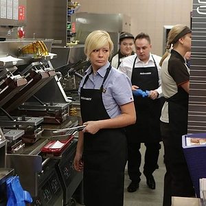 Fast food workers in the kitchen cooking