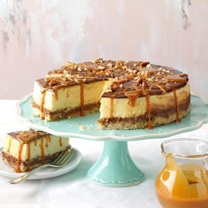 Best layered turtle cheesecake on a pie stand