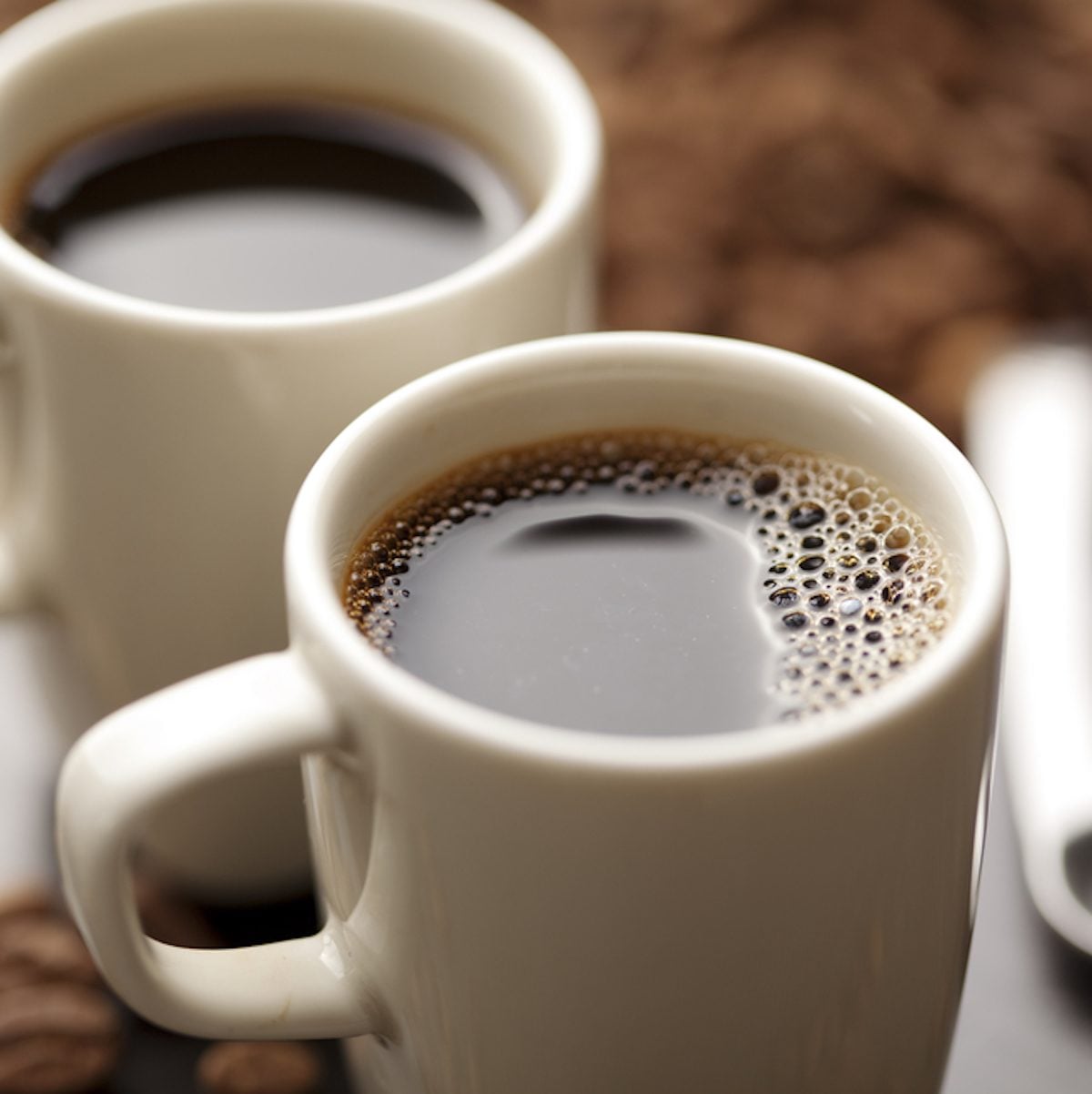 coffee cup filled with coffee beans;