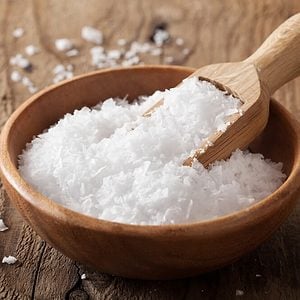 sea salt in wooden bowl and scoop