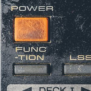 Rubber buttons on an old retro electronic remote control; dusty; old; remote