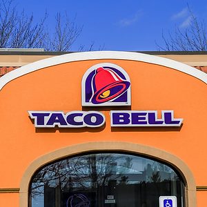 Exterior of Taco Bell fast-food restaurant with sign and logo