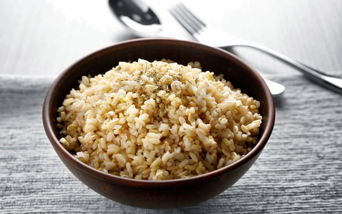 Bowl full of brown rice on napkin