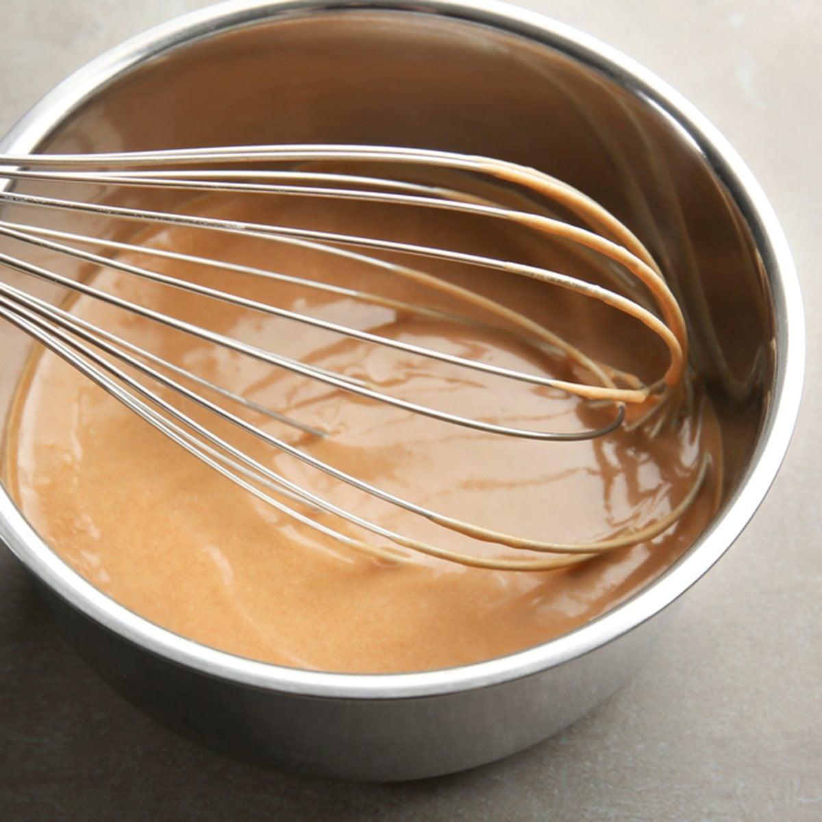 Delicious turkey gravy in saucepan on grey table; Shutterstock ID 670955209; Job (TFH, TOH, RD, BNB, CWM, CM): TOH