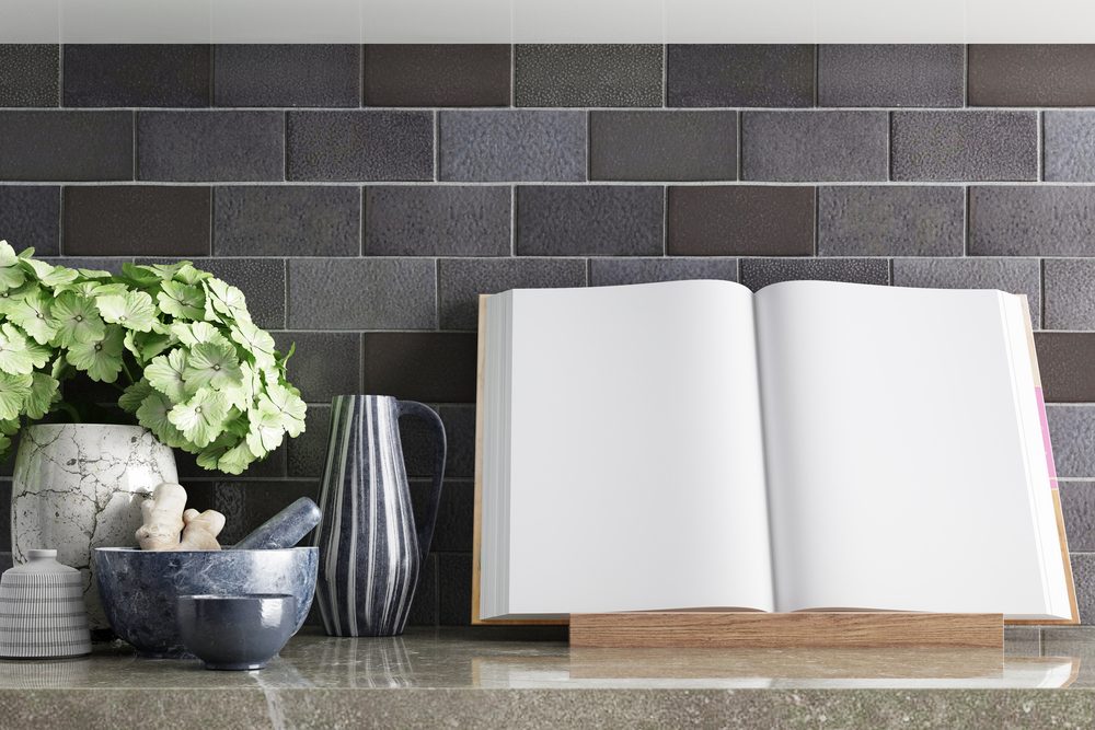 mock up pages of the cookbook on the table top with kitchen decor