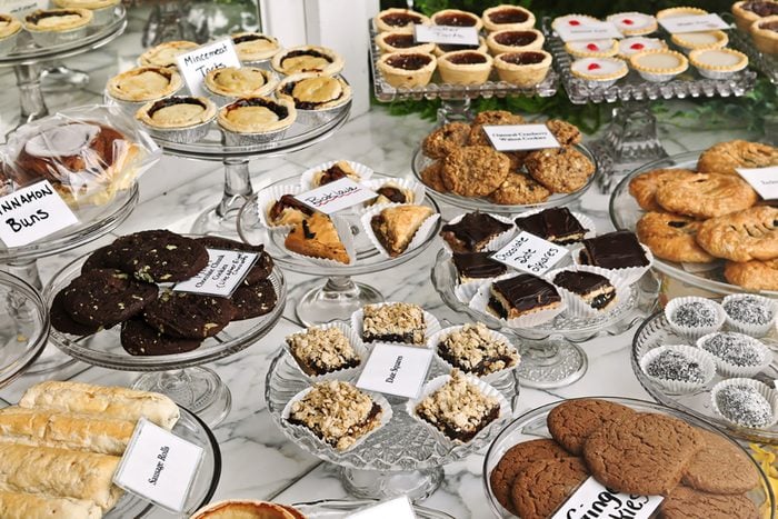 Various desserts on display in bakery window.