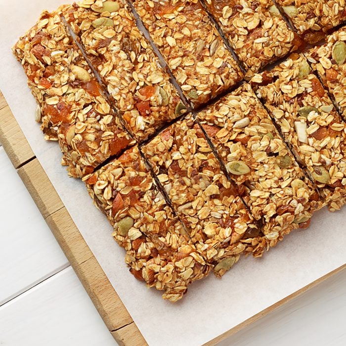 No baking granola bars on white wooden table.
