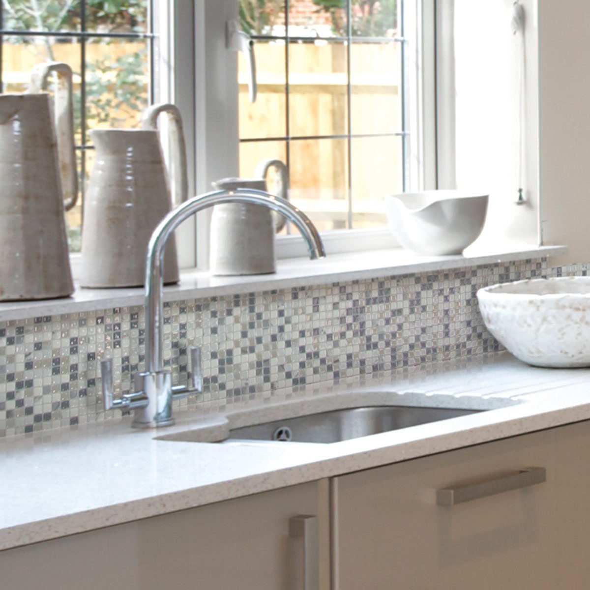 Kitchen with sticker tiles as its backsplash
