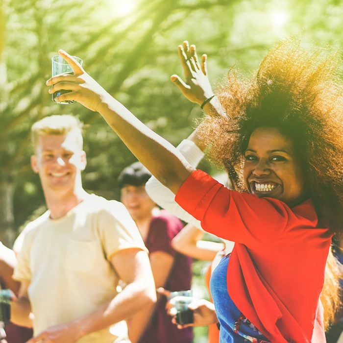 Multiracial young people dancing in forest party in summer time
