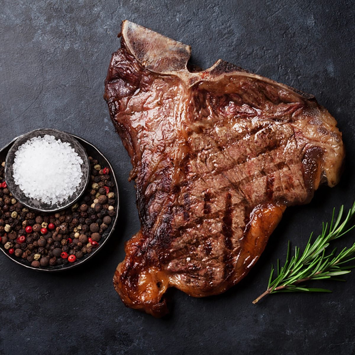 Grilled T-bone steak on stone table.