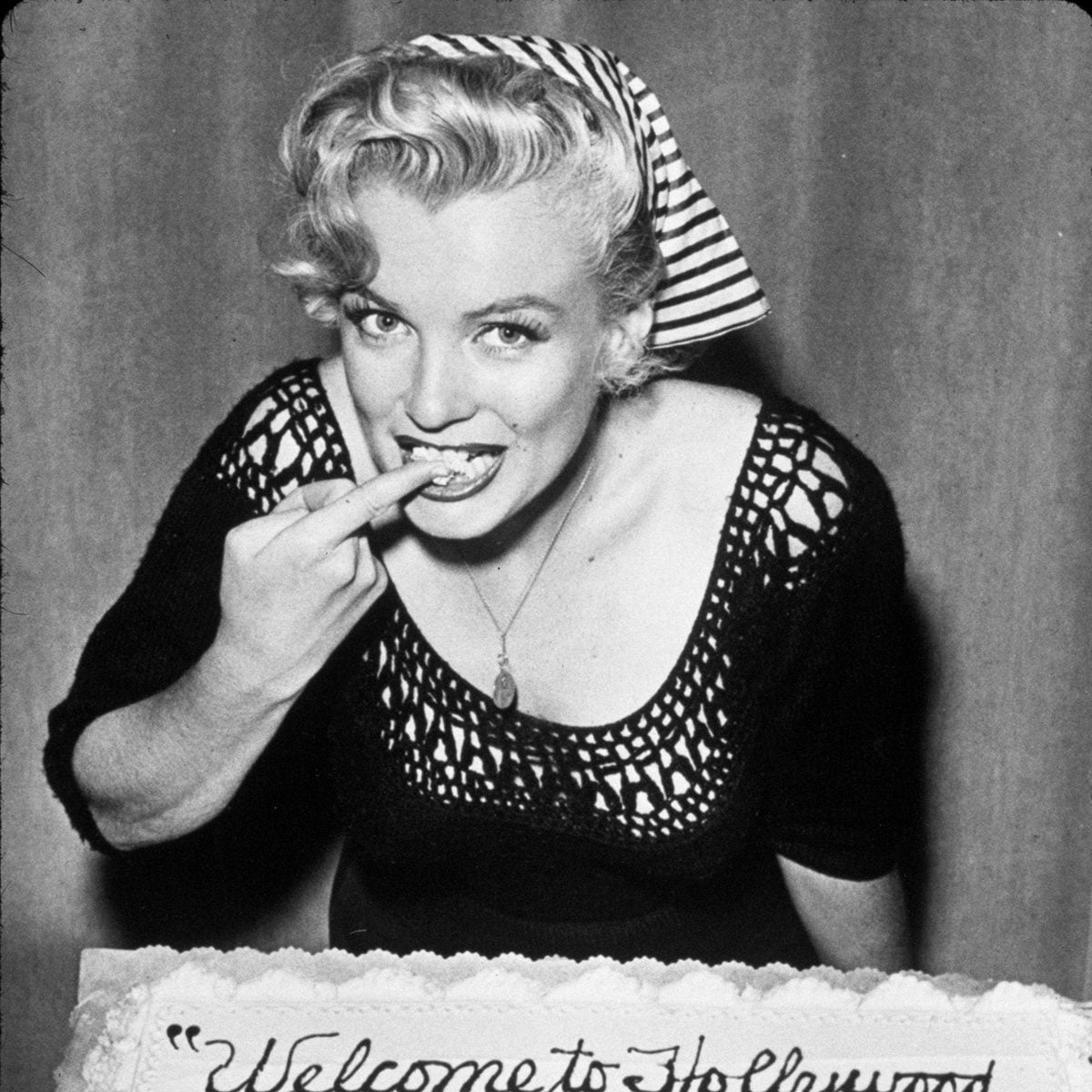 No Merchandising. Editorial Use Only Mandatory Credit: Photo by SNAP/REX/Shutterstock (390877mp) FILM STILLS OF 1952, CAKE, EATING, MARILYN MONROE, RADIO BROADCAST, FINGER, CREAM, HEAD SCARF IN 1952 VARIOUS