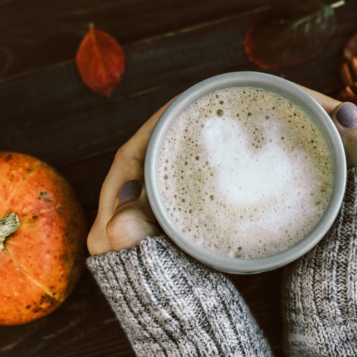 Cup of Spicy pumpkin latte in Woman