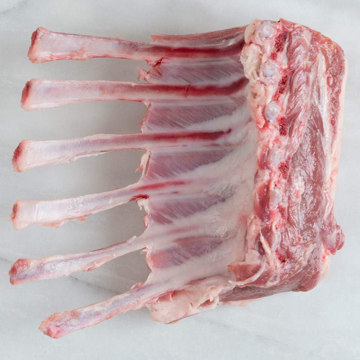 Directly above view of prime rib on marble background.