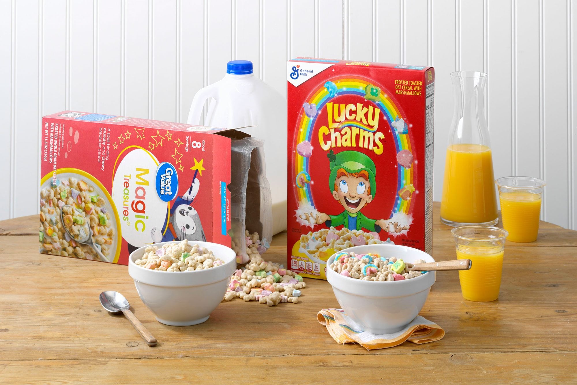 General Mills' Lucky Charms and Walmart's Great Value Magic Treasures on a wood table with orange juice and milk