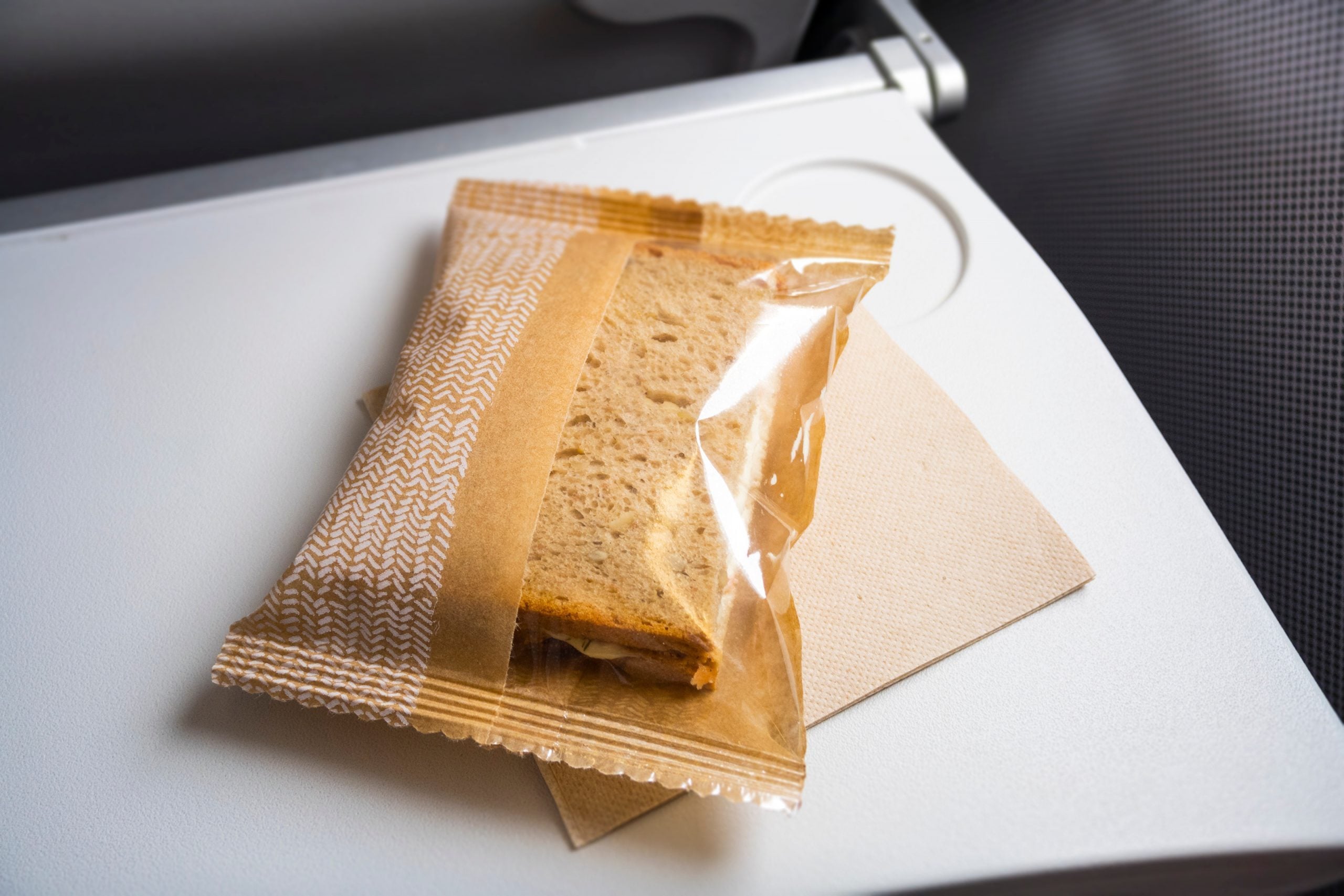 Close-Up Of a Sandwich on an airplane table
