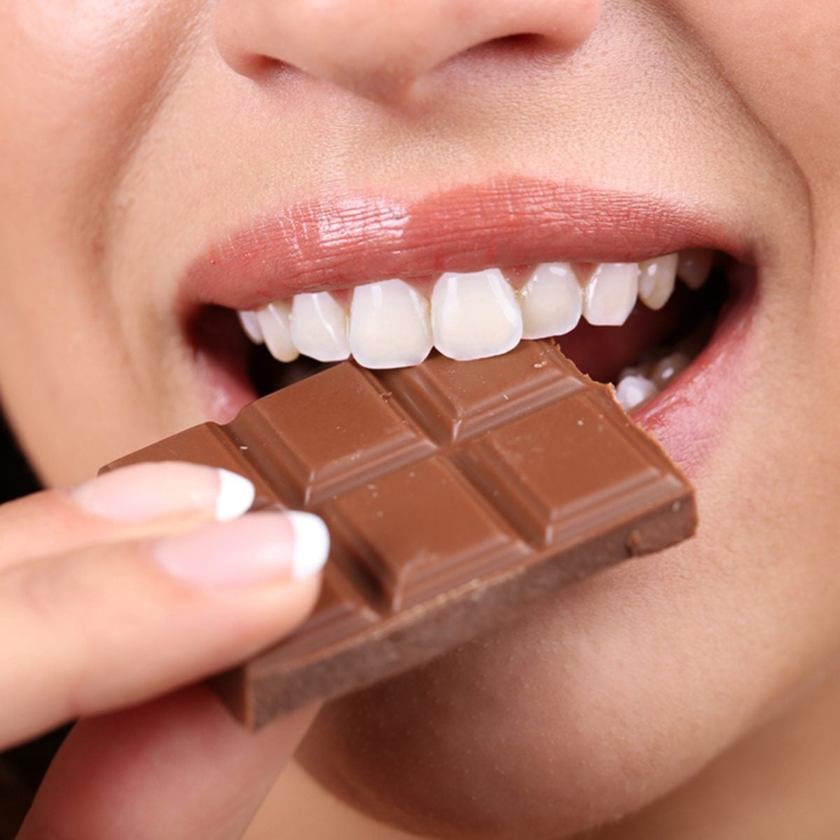 Closeup of woman eating chocolate