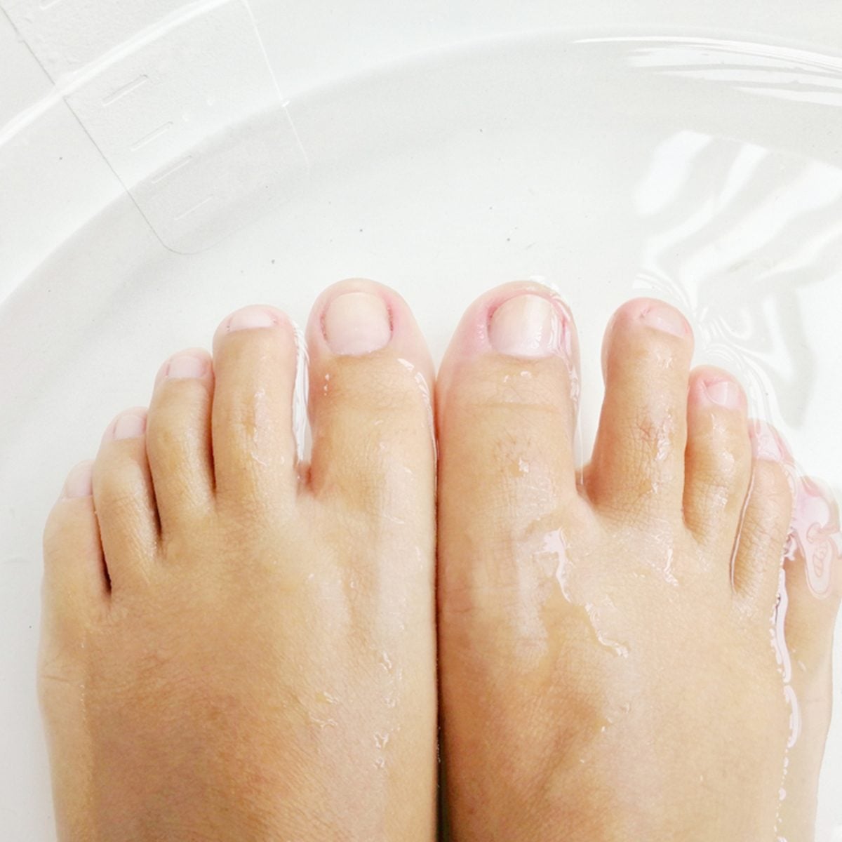 Women soak foots in the tub to relax and ready for cutting nails.