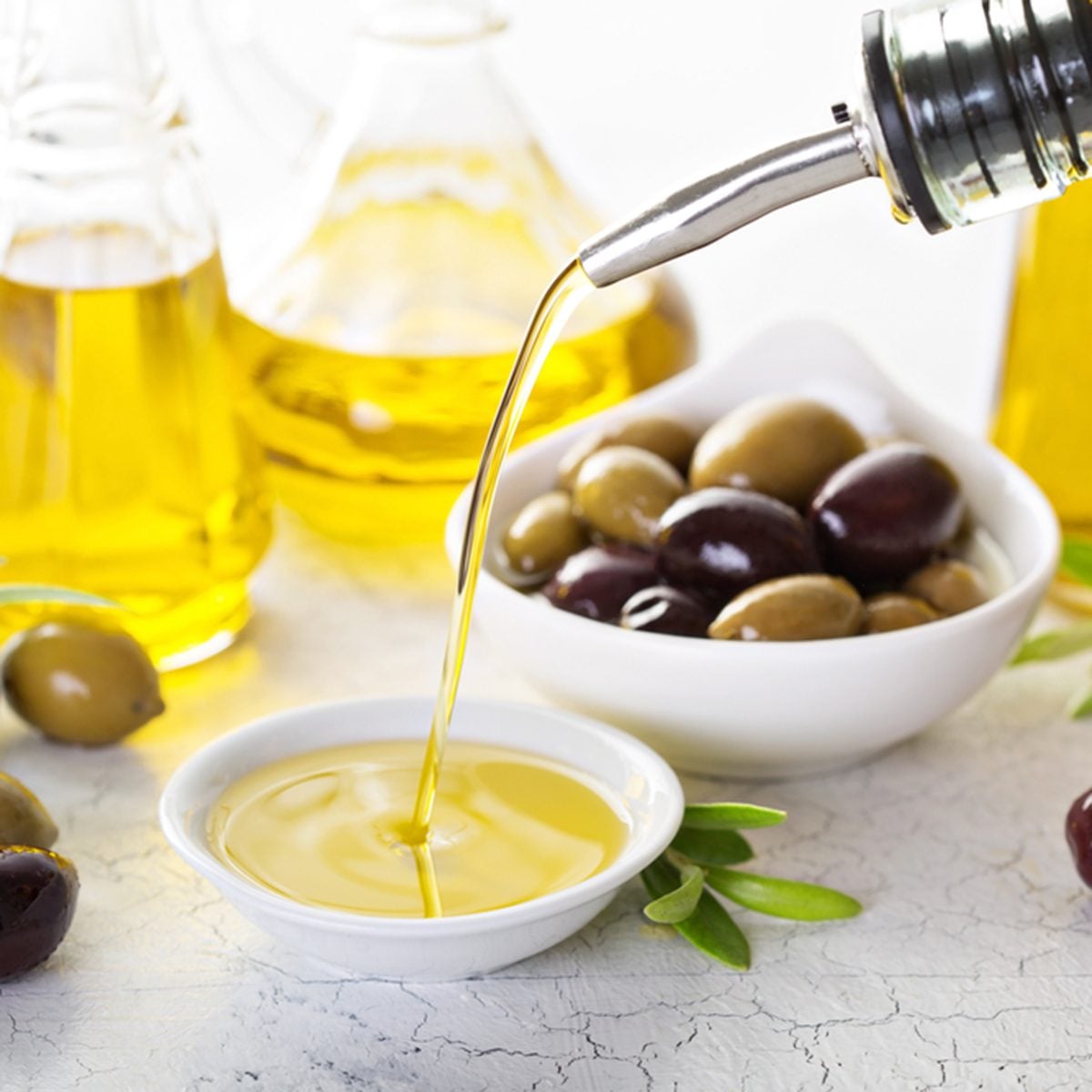 Olive oil in vintage bottles and small bowl