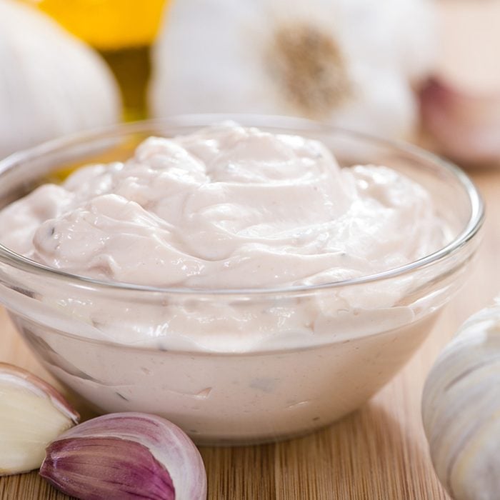 Homemade Aioli (garlic dip) on wooden background