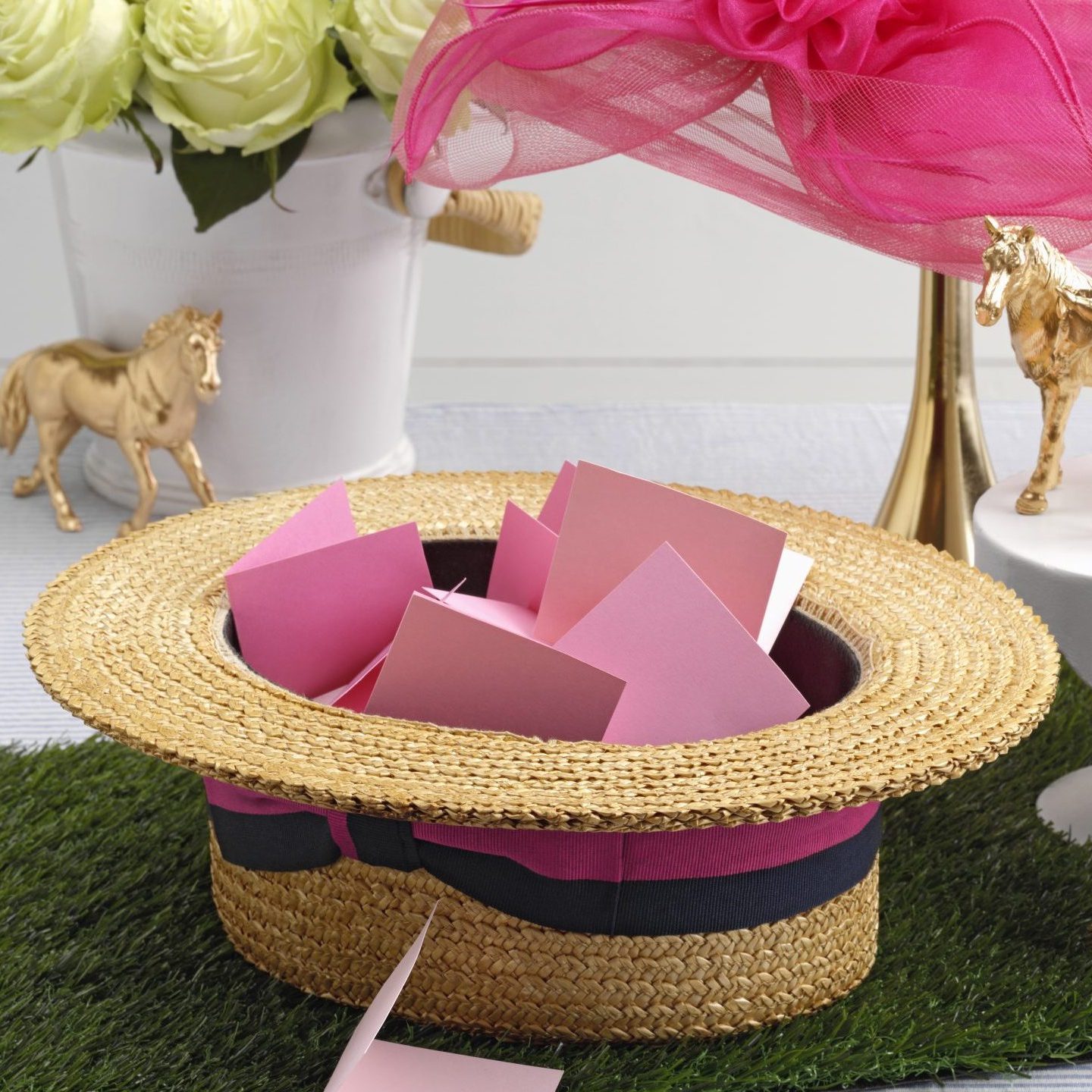 bunch of folded papers in an upside-down kentucky derby hat