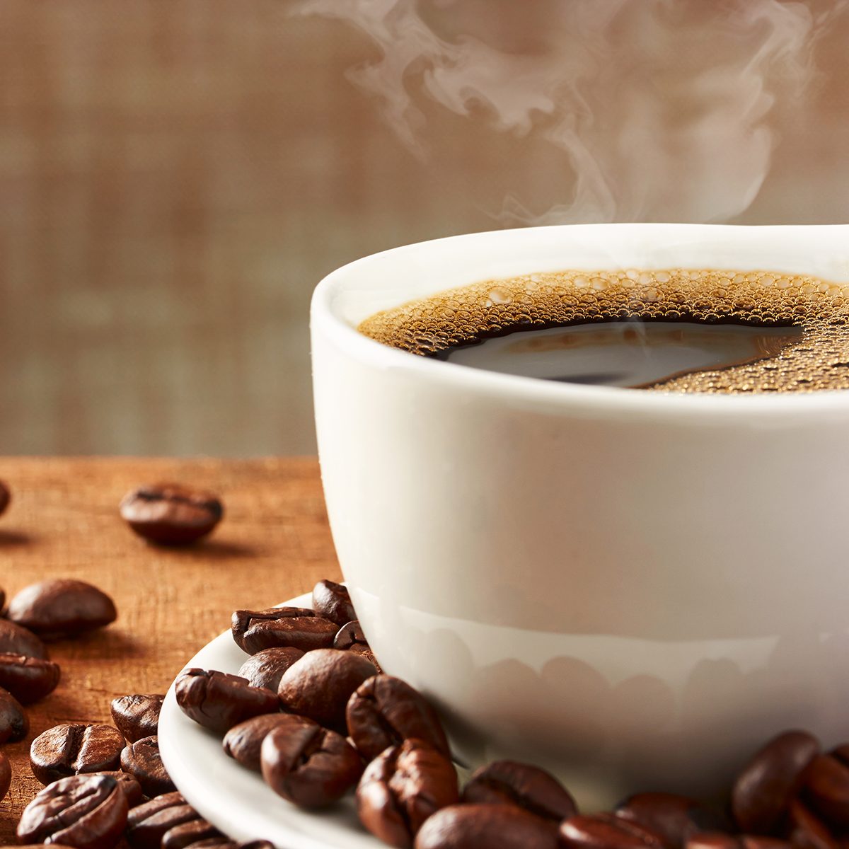 Coffee cup and coffee beans on table