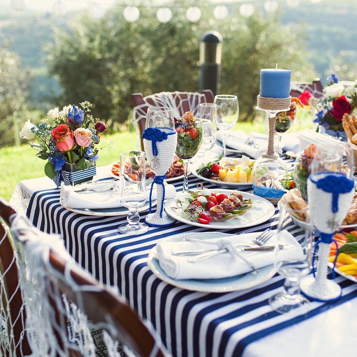 Lunch in the open air. Many dishes on the table.