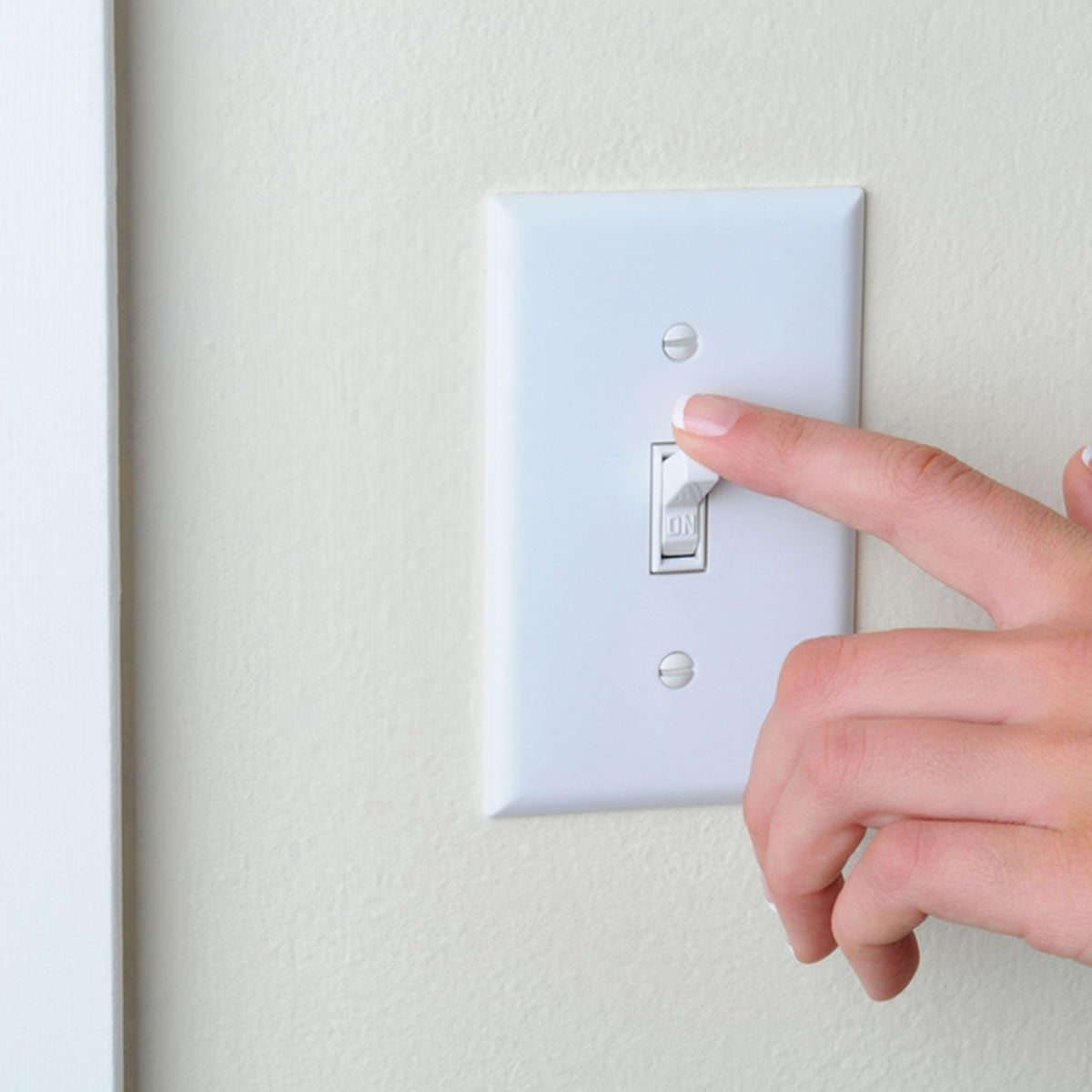 Womans hand with finger on light switch, about to turn off the lights. Closeup of hand and switch only. Horizontal format.; Shutterstock ID 95322187; Job (TFH, TOH, RD, BNB, CWM, CM): Taste of Home