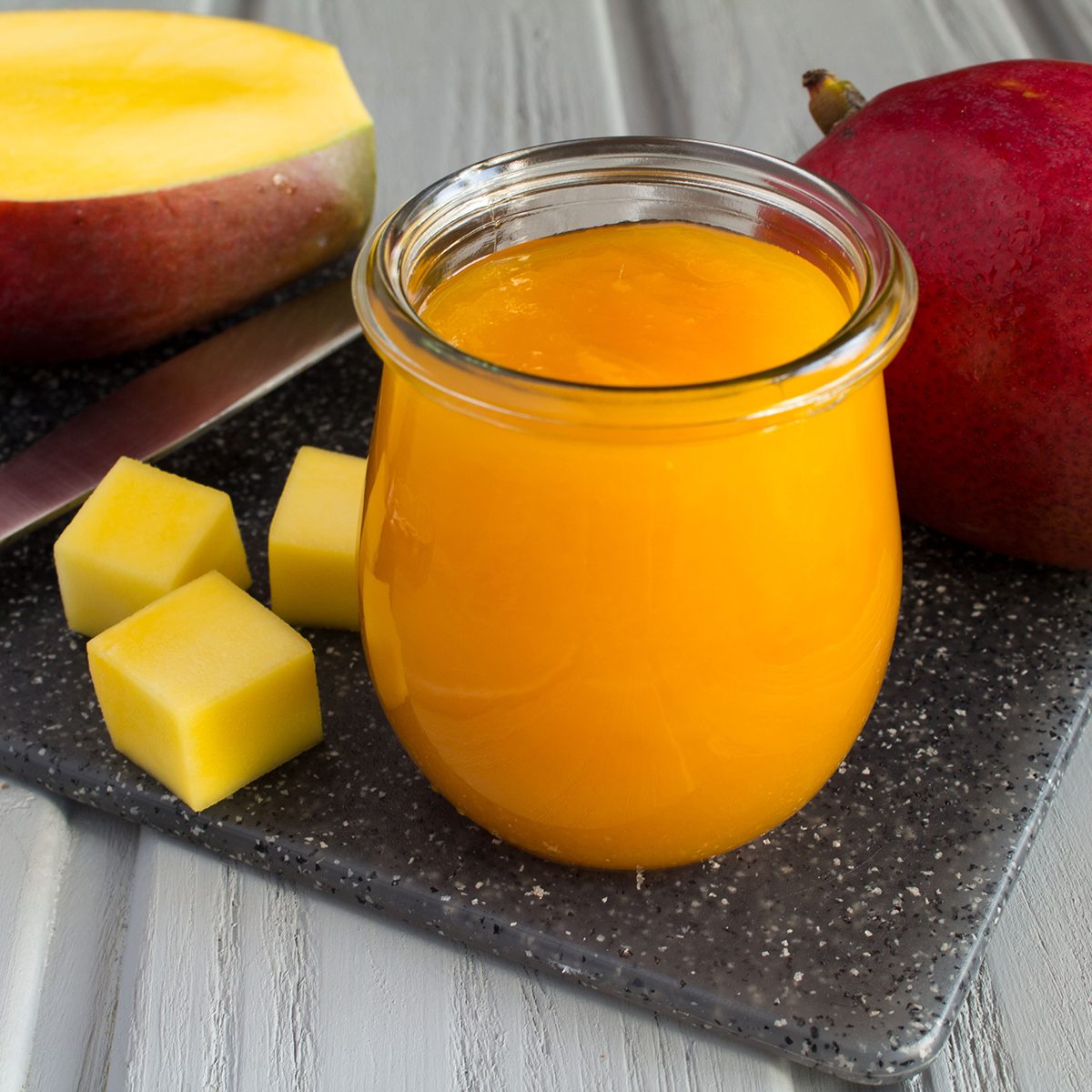 Puree with mango and ingredient on the grey cutting board