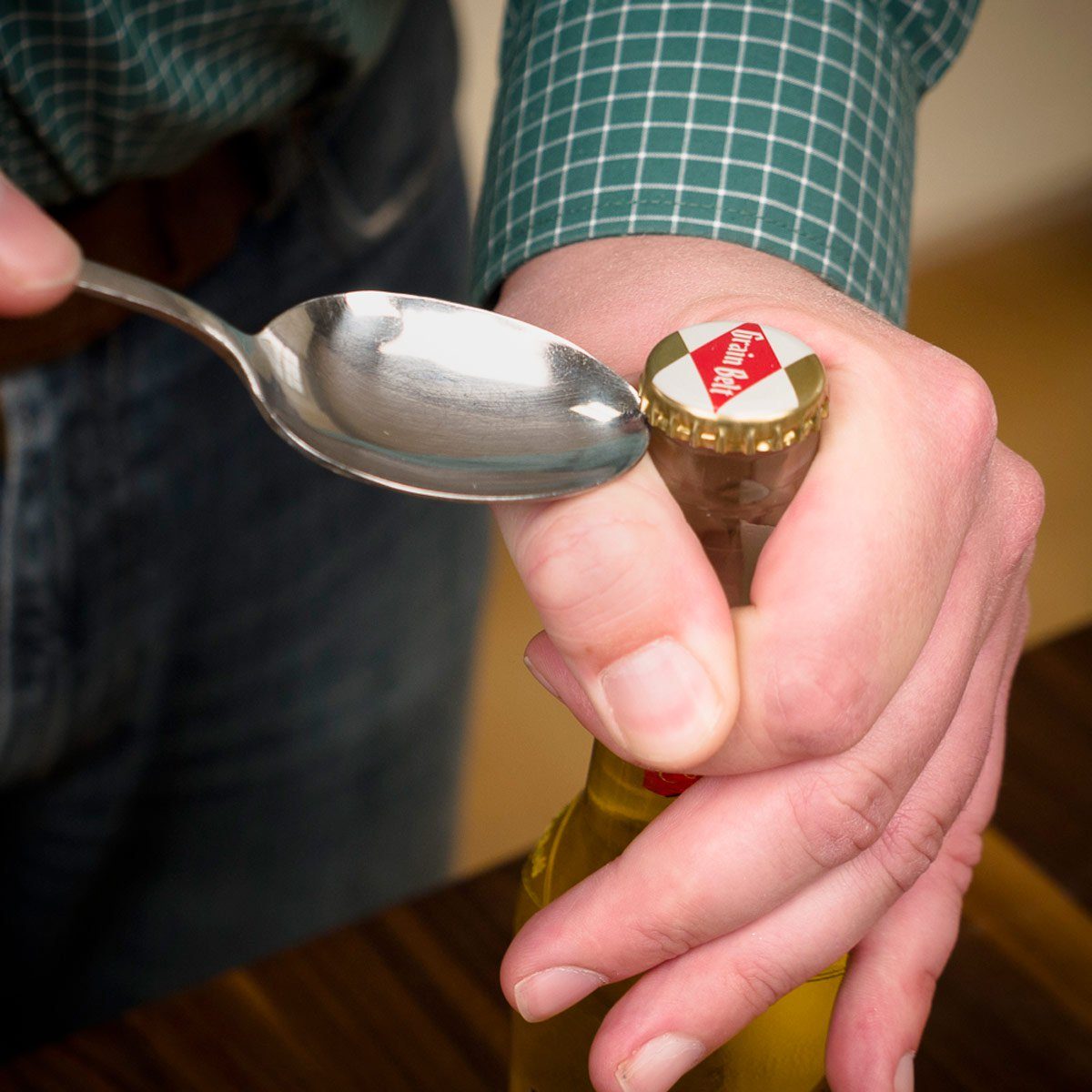 Opening bottle with spoon