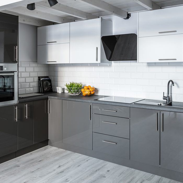 Modern kitchen with white brick tiles and wooden ceiling