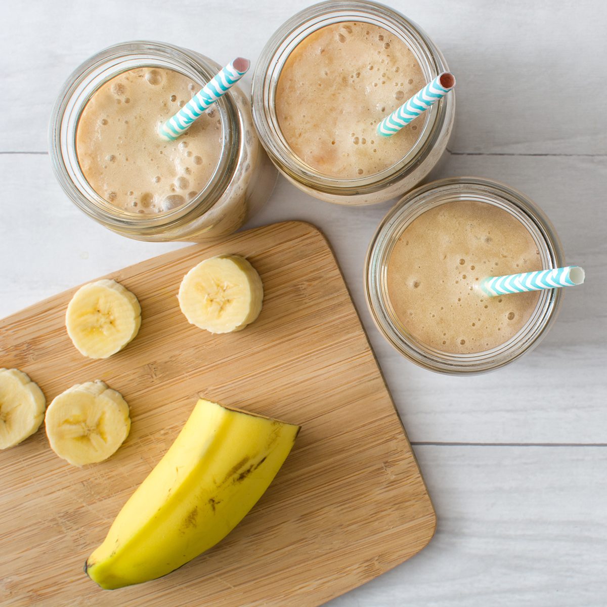 Banana smoothie on a white wooden table