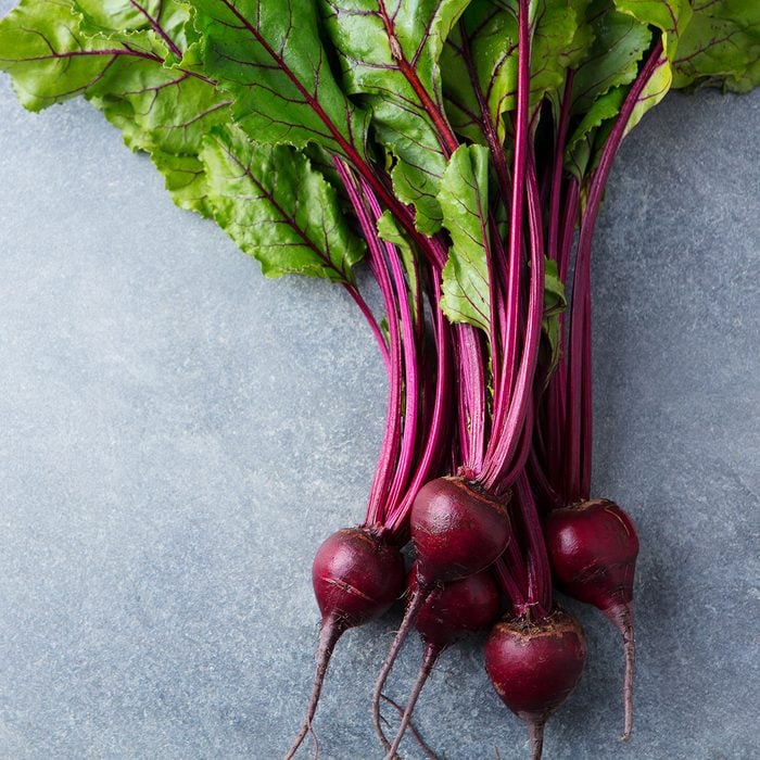 Beet, beetroot bunch on grey stone background.