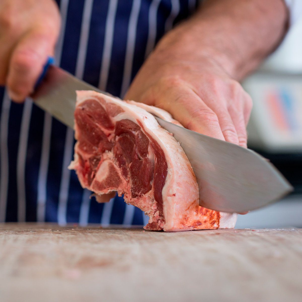 man slices raw meat