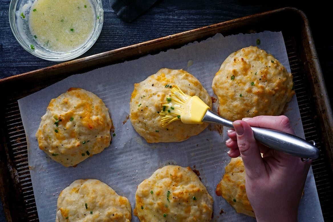 basting herb butter onto baked Red Lobster cheddar bay biscuits red lobster cheddar bay biscuits