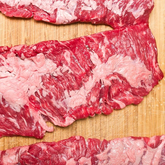 Skirt steak on wood cutting board