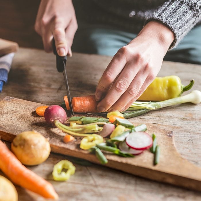 Woman Chopping food ingredients