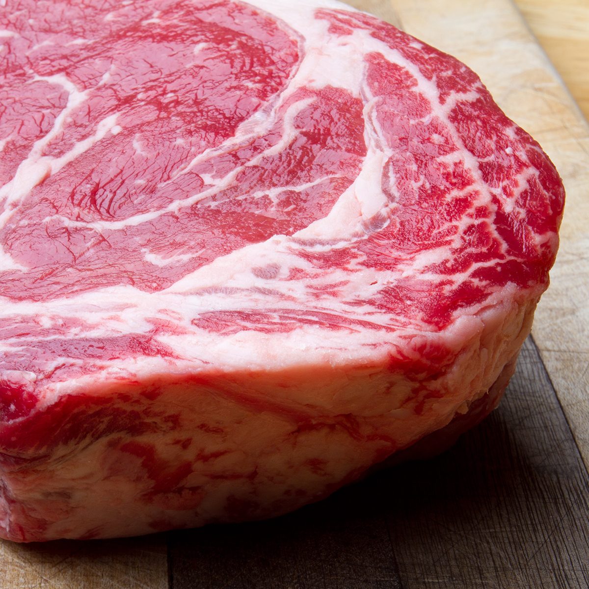 Thick Bone-In Rib Eye Steak on a cutting board