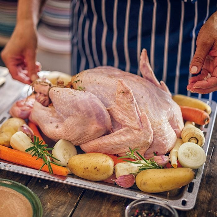 Preparing stuffed turkey with vegetables and other ingredients for holidays