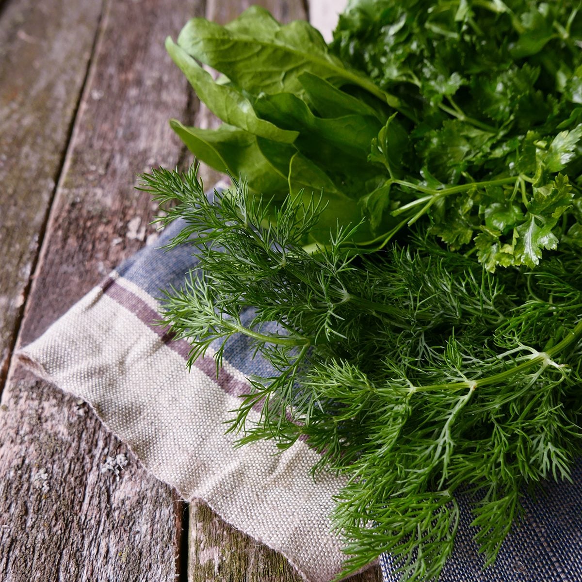 fresh greens on a wooden table linen napkin copyspace