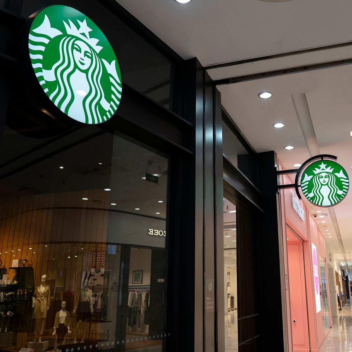 TIANJIN, CHINA - 2020/03/22: A Starbucks coffee store in a shopping mall. After nearly two months of closure by the COVID-19 epidemic situation in China, the Starbucks reopened most of stores in China. Customers are asked to take a temperature check before entering the store, and seated one people one table when dining in the store, otherwise encouraged to take out.
