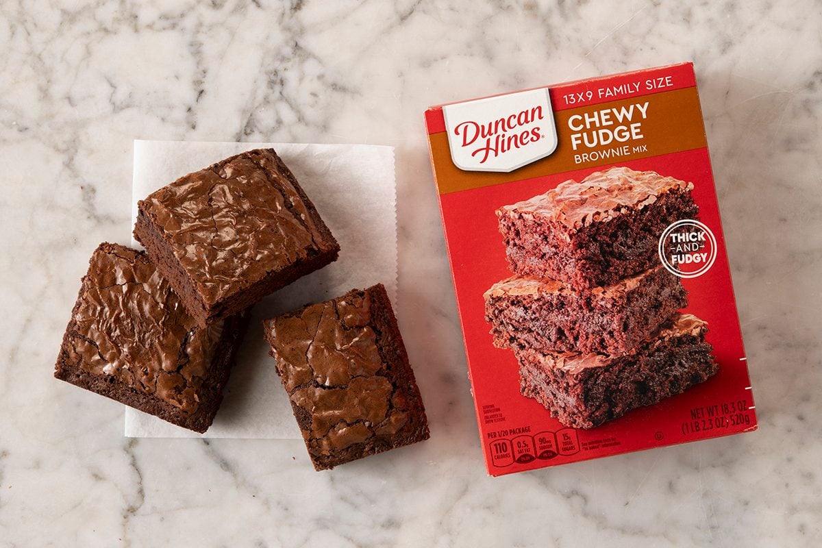 Duncan Hines Chewy Fudge Brownie Mix In Package On Marble With Pieces