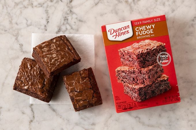 Duncan Hines Chewy Fudge Brownie Mix In Package On Marble With Pieces