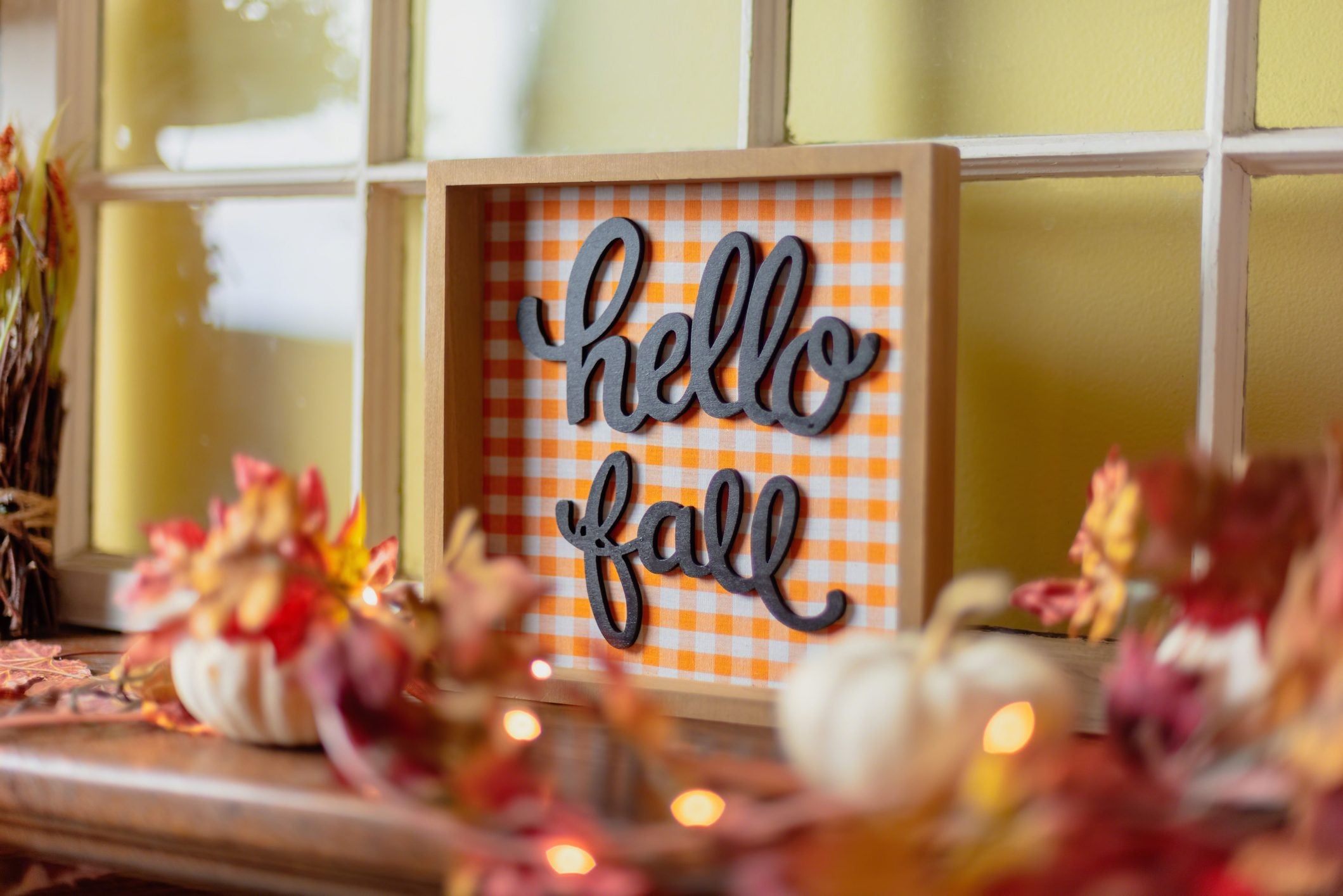 Closeup of orange fall decorations on mantel
