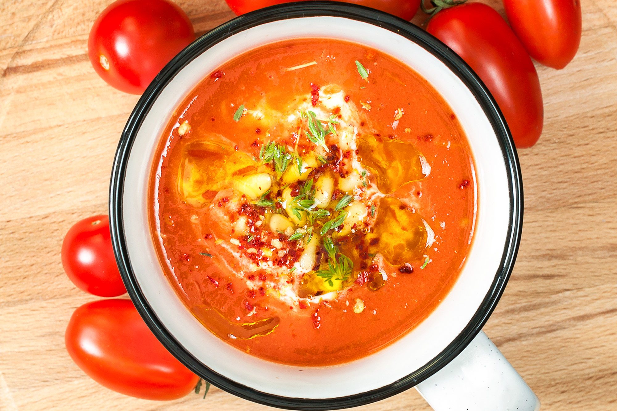 Tomato Soup And Tomatos On Wooden Surface