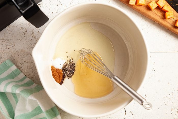 Whisking spices and honey and other ingredients