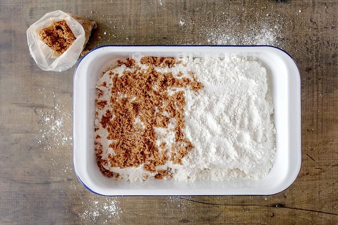 cake mix and brown sugar added to the pan filled with cinnamon dump cake before baking