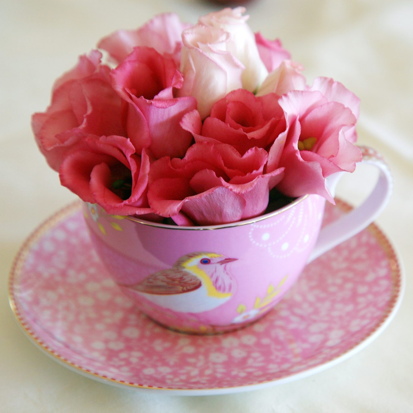 Arrangement of flowers in a teacup vase